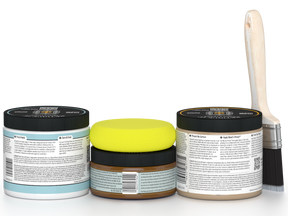 Three paint cans with lids in different colors and a paintbrush on a white background