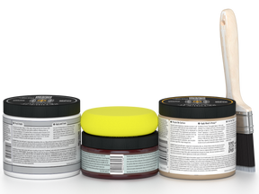 Three jars of paint with different colored lids and a paintbrush on a white background