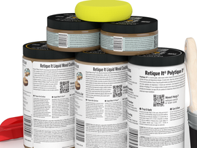 Multiple containers of Retique It wood coating with a yellow foam block on top.