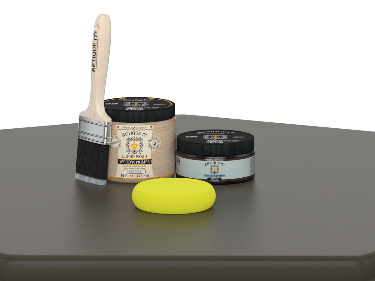 Paintbrush, wooden primer jar, and yellow sponge on a gray surface with a white background