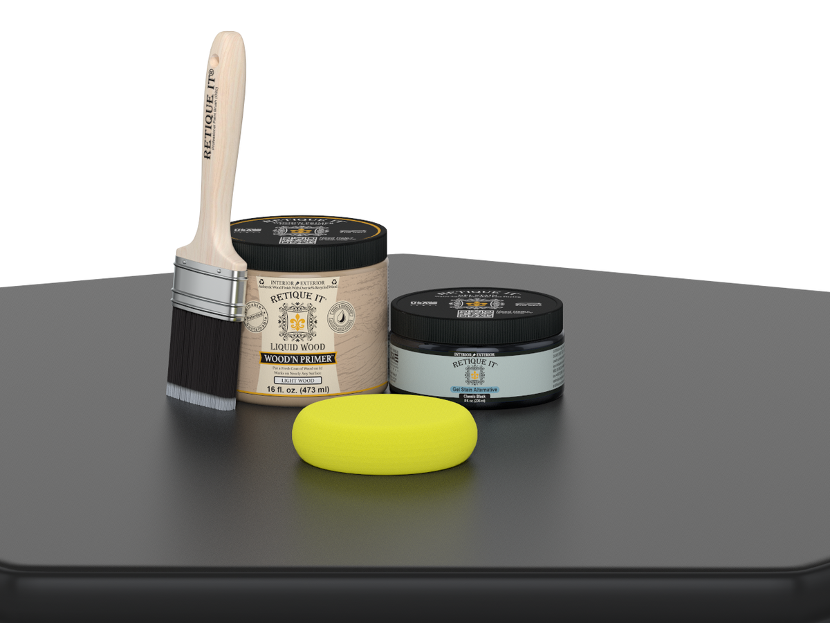 Paintbrush, wooden primer jar, and yellow sponge on a dark surface with a white background