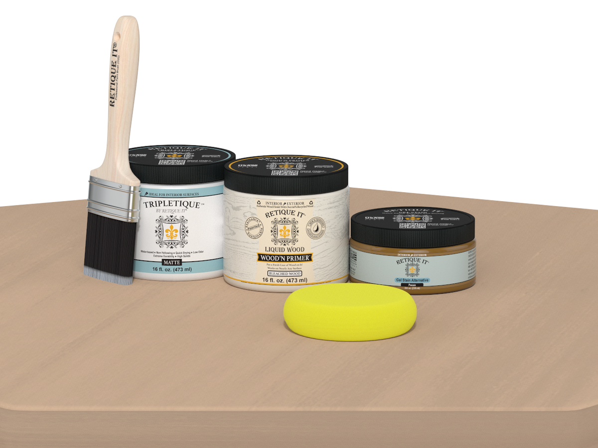 Triplettique paint products including a brush, jars, and a sponge on a beige surface.