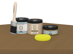 Collection of paint cans and a brush on a brown surface with a white background