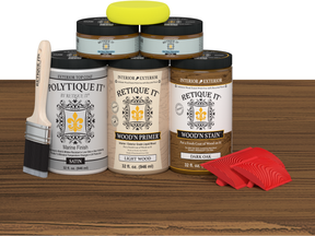 Collection of Polytique wood care products including cans, a brush, and a sponge on a wooden surface.