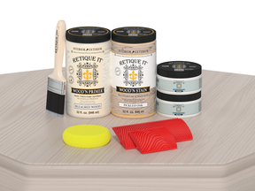 Wood staining kit with primer, stain, and applicators on a wooden surface