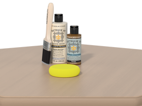 Rectique It wood care products including a brush, bottle, and yellow sponge on a beige surface.
