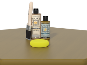 Set of Etiquette Wood Care products including a brush, bottle, and sponge on a beige surface.
