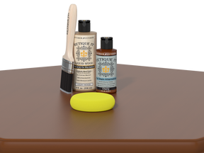 Set of painting supplies including a brush, bottles, and a sponge on a brown surface with a white background.