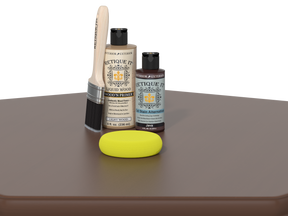 Set of Etiquette Wood Care products including a brush, bottle, and yellow sponge on a brown surface.