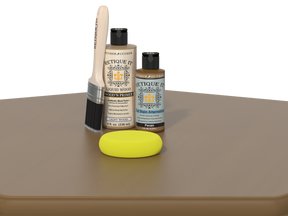Set of wood care products including a brush, bottles, and a sponge on a brown surface with a white background.