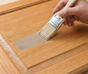 Retique It Universal Liquid Wood Kit in Light Wood applied to cabinet surface, showcasing wood grain and smooth finish.